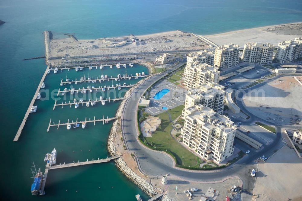 Ras Al Khaimah from the bird's eye view: The Marina Apartments and the Al Hamra Marina Yacht Club in the arab emirate Ras Al Khaimah. The apartments and the yacht club are part of the Al Hamra Village Project, the second largest construction project of Ras Al Khaimah. The project is realized by the state-owned company Al Hamra Real Estate