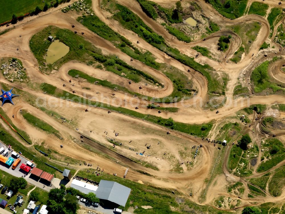 Reisersberg from above - The motocross circuit in Reisersberg in the state of Bavaria. The ACC race is taking place. The track is very close to the village of Reisersberg and is run by the association MCC Röhrnbach-Reisersberg. It is the site of yearly motocross, enduro and youth races