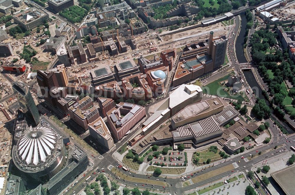 Aerial photograph Berlin - The new buildings at Potsdamer Platz as the Sony Center, the Kollhoff Tower, Shopping Centre, Potsdamer Platz Arcades and the Musical - Stage - Theater nestle with distinctive layouts of announces to the State Library. This neighborhood has become a tourist hotspot in Berlin-Mitte since it was built