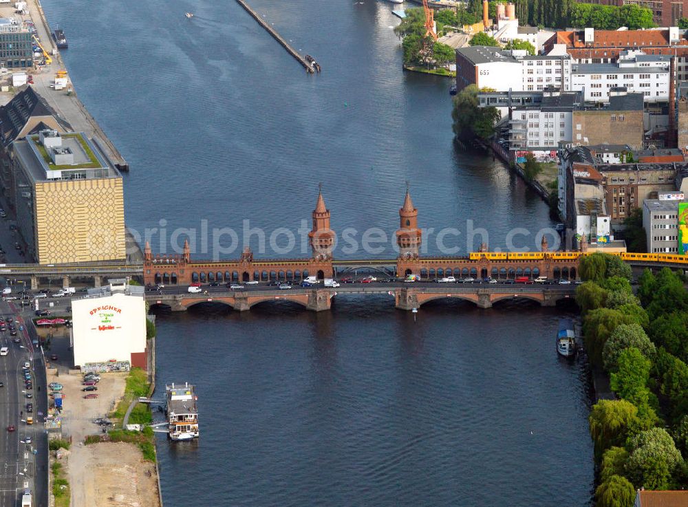 Berlin from above - The Oberbaum bridge in Berlin as part of connecting of the inner ring road, connects the districts of Kreuzberg and Friedrichshain over the Spree river. It is the landmark of the district of Friedrichshain-Kreuzberg. After the reunification the bridge extensively repaired for a total of 70 million DM