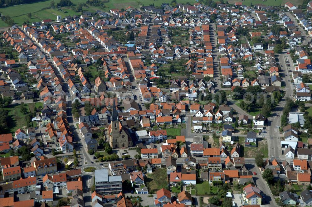 Aerial image HAMBRÜCKEN - Blick auf die Pfarrkirche Hambrücken und das Wohngebiet entlang der Kirchstraße und der Rheinstraße. Hambrücken ist eine Gemeinde im Landkreis Karlsruhe in Baden-Württemberg. Hambrücken liegt in der Oberrheinebene westlich der Bundesautobahn 5, rund 10 km nord-nordwestlich von Bruchsal. Obwohl der Ort in kirchlichem Besitz war, wurde erst 1510 erstmals eine Pfarrkirche erwähnt. Diese Holzkirche wurde von Fürstbischof Damian Hugo von Schönborn durch eine massive Barockkirche mit Zwiebelturm ersetzt, die er 1742 selbst einweihte. Kontakt: Gemeinde Hambrücken, Hauptstr. 108, 76707 Hambrücken, Tel. +49 (0)72 55 71 00 0, Fax +49 (0)72 55 71 00 88, e-mail: gemeinde@hambruecken.de; Kontakt Katholisches Pfarramt: Pfarrer Armin Haas und Klaus Zöllner, Pfarrbüro: Frau Kretzler, Kirchstr. 2, Tel. +49 (0)7255 9410, Fax +49 (0)7255 6931