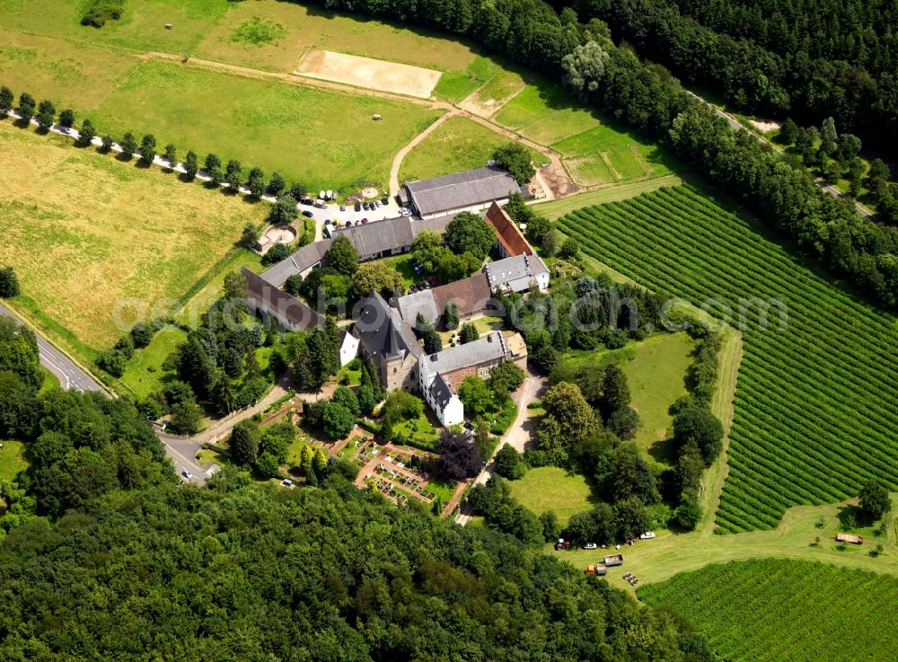 Aerial photograph Langerwehe - St. Catherine's parish church in the district of Düren and lying to Langerwehe part Wenau community belonging. The church dates from the 12th Century and today serves both religious and social functions. The parish is situated on the edge of a forest and is affected by a road