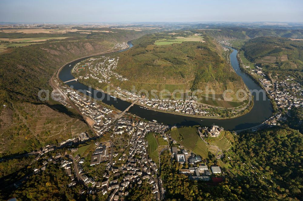 Cochem from the bird's eye view: The Cochem Castle is a castle at the Mosel river in the Rhineland-Palatinate town of Cochem. After it had been destroyed in the 17th century, the businessman Louis Frédéric Jacques Ravené rebuilt the castle according to the taste of romanticism between 1868 to 1877. Today the castle is a museum and event space. The castle hill is used for winegrowing