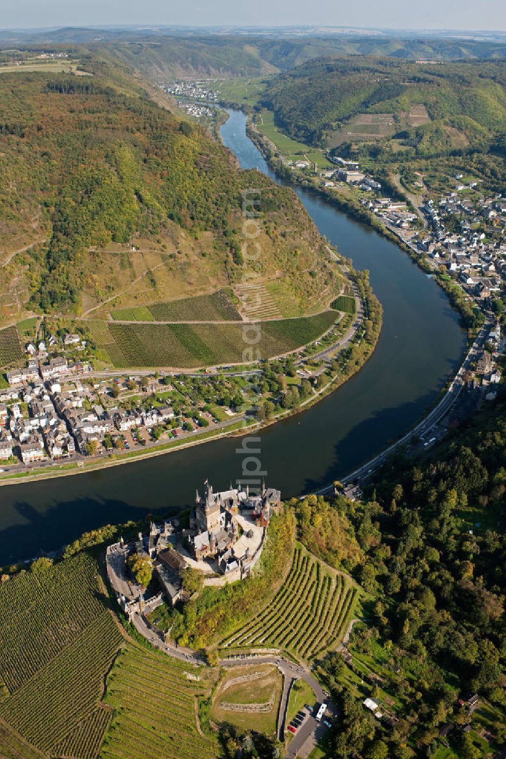 Aerial photograph Cochem - The Cochem Castle is a castle at the Mosel river in the Rhineland-Palatinate town of Cochem. After it had been destroyed in the 17th century, the businessman Louis Frédéric Jacques Ravené rebuilt the castle according to the taste of romanticism between 1868 to 1877. Today the castle is a museum and event space. The castle hill is used for winegrowing