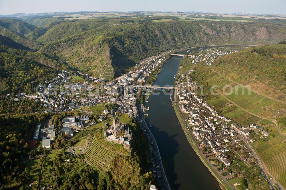 Aerial photograph Cochem - The Cochem Castle is a castle at the Mosel river in the Rhineland-Palatinate town of Cochem. After it had been destroyed in the 17th century, the businessman Louis Frédéric Jacques Ravené rebuilt the castle according to the taste of romanticism between 1868 to 1877. Today the castle is a museum and event space. The castle hill is used for winegrowing