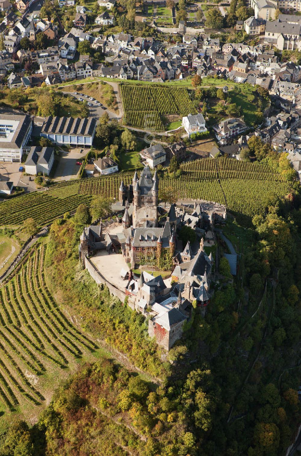 Cochem from above - The Cochem Castle is a castle at the Mosel river in the Rhineland-Palatinate town of Cochem. After it had been destroyed in the 17th century, the businessman Louis Frédéric Jacques Ravené rebuilt the castle according to the taste of romanticism between 1868 to 1877. Today the castle is a museum and event space. The castle hill is used for winegrowing