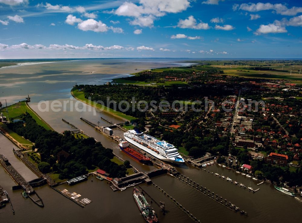 Brunsbüttel from above - The watergate of the North-East Sea Channel in Brunsbüttel in the state of Schleswig-Holstein. The lock is located at the city limits and at the mouth of the river Elbe into the North Sea. The channel is the most used artificial water way in the world. The watergate is an important tourist site today