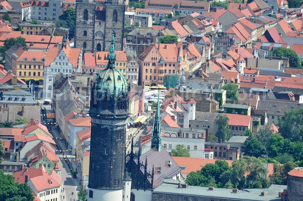 Aerial image Wittenberg - View of the castle church of Wittenberg. The castle with its 88 m high Gothic tower at the west end of the town is a UNESCO World Heritage Site. The first mention of the castle dates from 1187. It gained fame as in 1517 the Wittenberg Augustinian monk and theology professor Martin Luther spread his 95 disputation. Today, the castle is a hostel, the host of the Riemer Museum and of local history collections