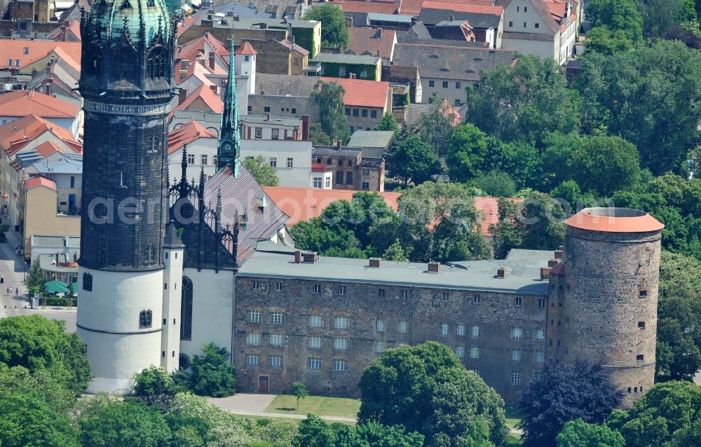 Wittenberg from above - View of the castle church of Wittenberg. The castle with its 88 m high Gothic tower at the west end of the town is a UNESCO World Heritage Site. The first mention of the castle dates from 1187. It gained fame as in 1517 the Wittenberg Augustinian monk and theology professor Martin Luther spread his 95 disputation. Today, the castle is a hostel, the host of the Riemer Museum and of local history collections
