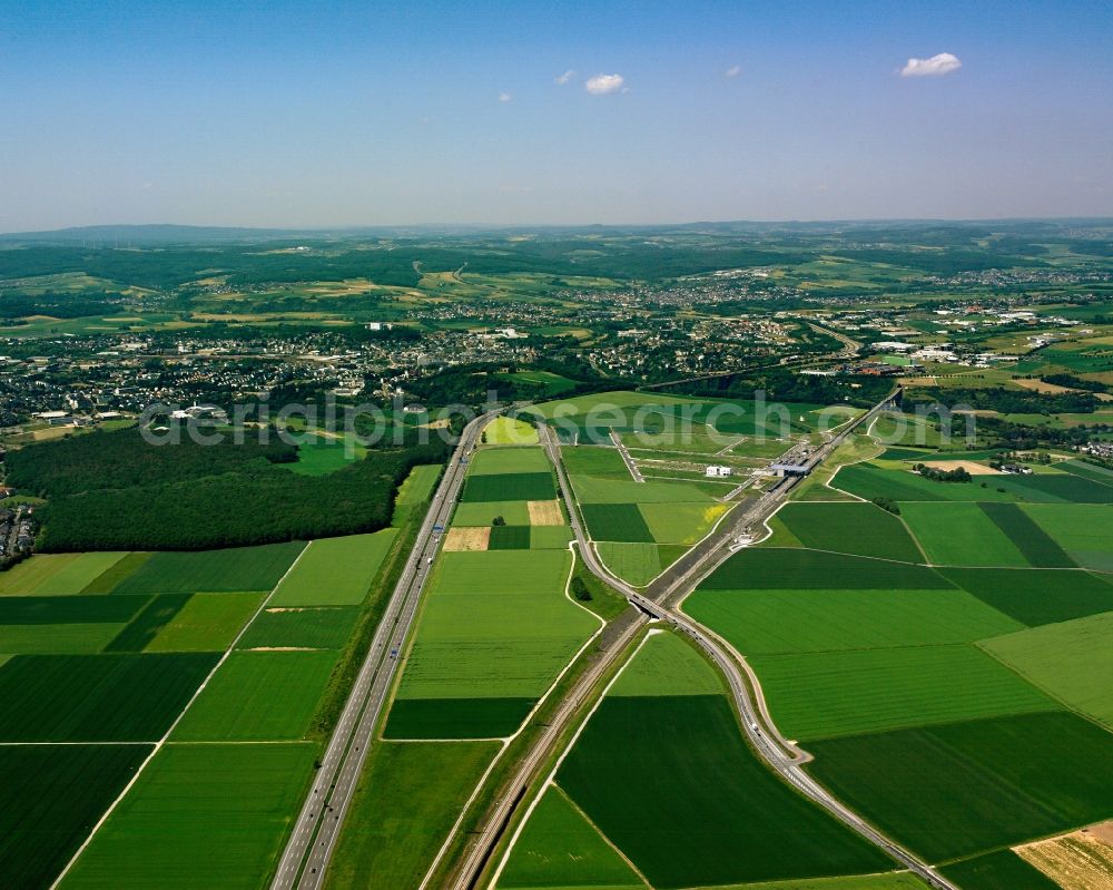 Dierdorf from above - The high speed rail line of Cologne-Rhine/Main and the highway Autobahn A3 near Dierdorf in the state of Rhineland-Palatinate. The closeness of both transit ways is one of the distinct characteristics of the rail line in this area. The Autobahn circles around villages and cities and the rail runs beneath them through tunnels. Outside of the residential and urban areas, both go together