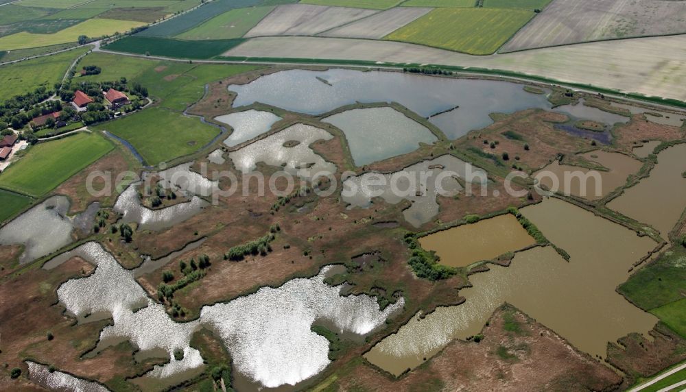 Aerial image Krummhörn - The lakes at the hamlet of Hauen in the borough of Krummhörn in the state of Lower Saxony. The small group of lakes and ponds is adjacent to the national park Lowery Saxony Wadden Sea and lies in the west of the village