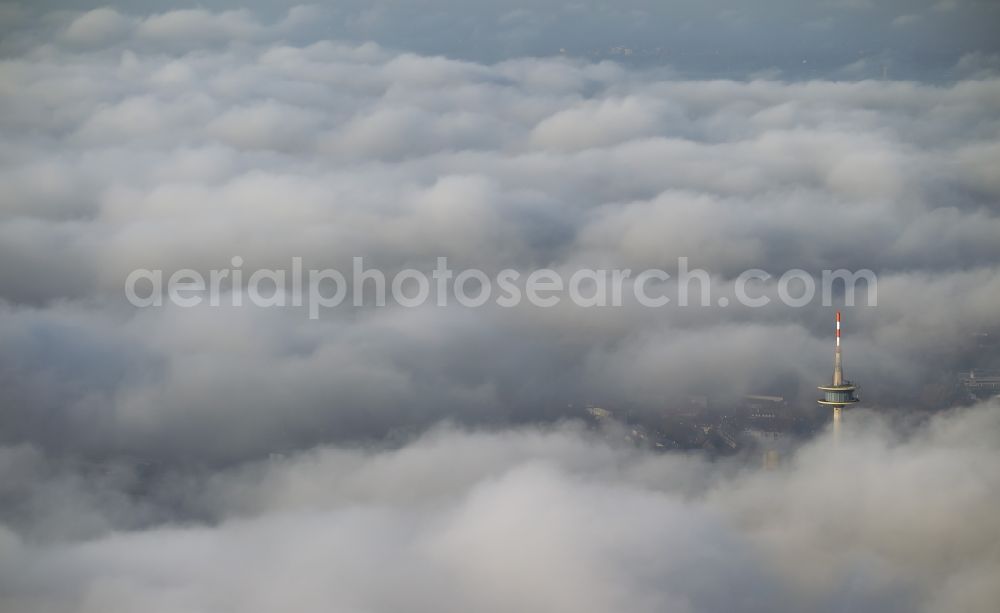 Aerial image Essen - View of the top of the telecommunication tower breaking through an impressive blanket of clouds over the city center of Essen in the state North Rhine-Westphalia. The autumn weather clouds are surrounding the television tower at its location in the Holsterhausen district and form a cloud bank over the Ruhr region city