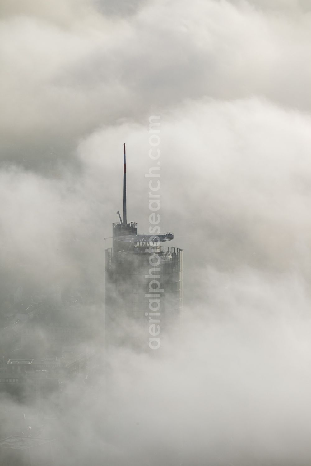 Aerial image Essen - View of the top of the RWE tower breaking through an impressive blanket of fog and clouds over the city center of Essen in the state North Rhine-Westphalia. The autumn weather clouds are surrounding the skyscraper headquarters of energy supplier RWE at Opernplatz and form a cloud bank over the Ruhr region city