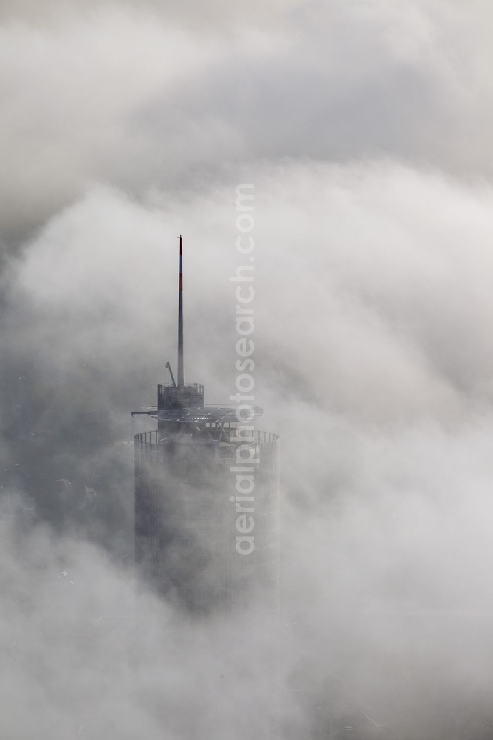 Aerial photograph Essen - View of the top of the RWE tower breaking through an impressive blanket of fog and clouds over the city center of Essen in the state North Rhine-Westphalia. The autumn weather clouds are surrounding the skyscraper headquarters of energy supplier RWE at Opernplatz and form a cloud bank over the Ruhr region city