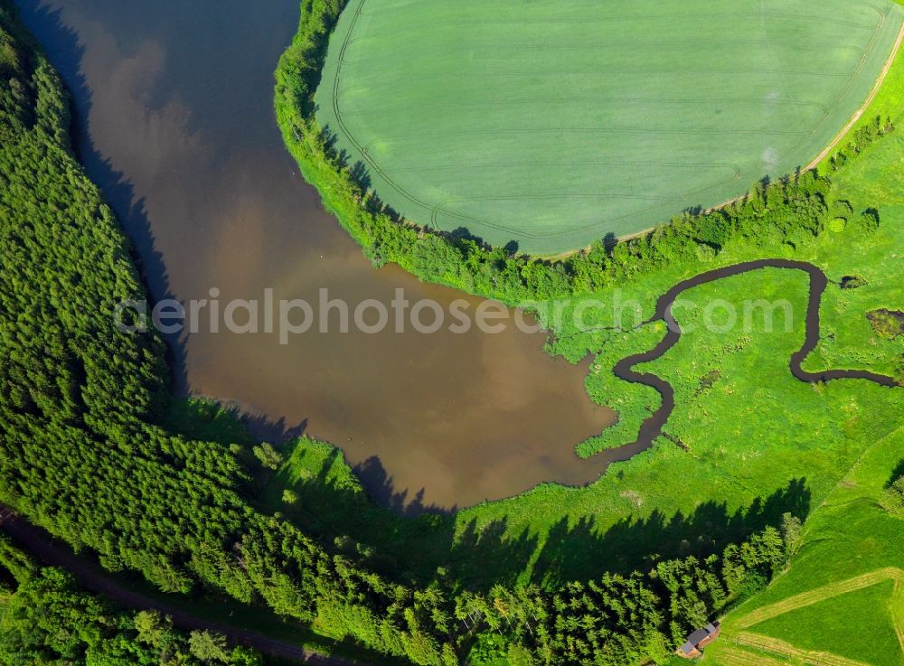 Schleiz from above - The barrier lake Lössau in the Langenbuch part of Schleiz in the state of Thuringia. The valley lock and lake have been created in 1985. They belong to a barrier lake system in the region and are used for drinking water supply. The water is located amidst the landscape of the Thuringian Shale Mountains