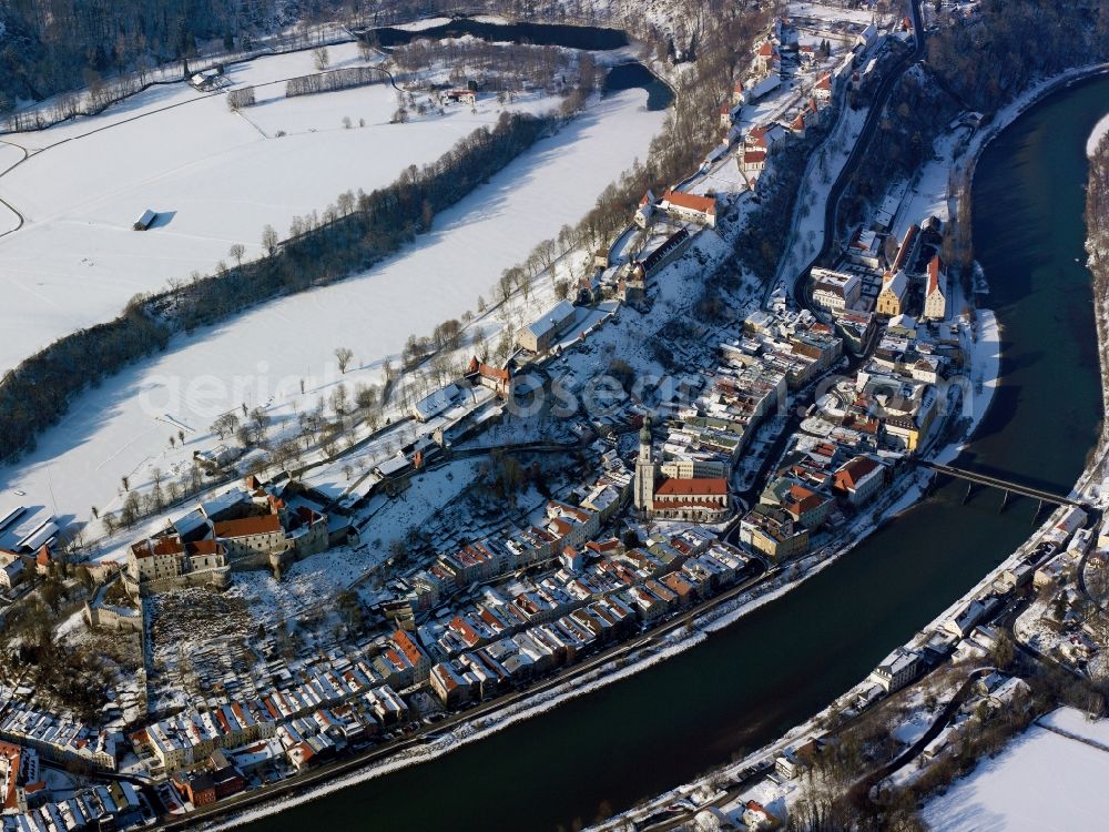 Burghausen from the bird's eye view: The snow covered city of Burghausen in the county district of Altötting in the state of Bavaria. The former seat of dukes and counts is the largest city in the region of Oberbayern. It is located on the river Salzach. Burghausen Castle rests along a ridgeline above the city centre. It is the longest Castle in Europe