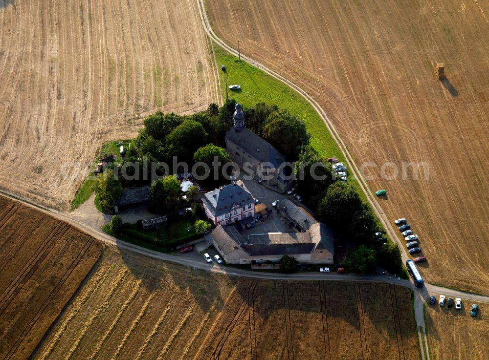 Niedermendig from the bird's eye view: The Sanctuary Frauenkirch wid first documented in 1279. The church is located outside of town. The Sanctuary is a multi-part complex of buildings surrounded by trees and surrounded by farmland