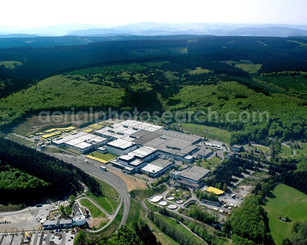 Warstein from above - The Warsteiner Brewery near Warstein in the state of North Rhine-Westphalia. The brewery is located in the South of the city amidst hills and forest. The Warsteiner Brauerei Haus Cramer KG is one of the largest breweries in Germany and produces beer for the domestic and foreign market. The site has been in use since the early 19th century. Today the company offers a huge selection of different beers and is one of the economy drivers in the region