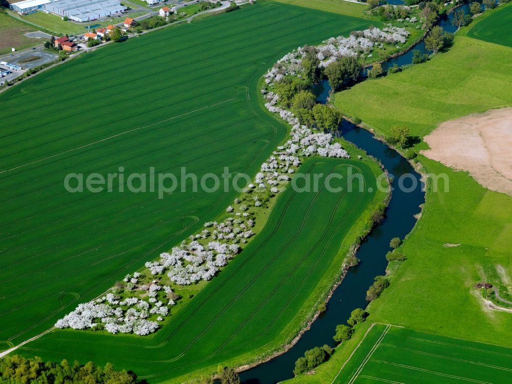 Creuzburg from above - The river Werra at the southern city border of Creuzburg in the state of Thuringia. The river runs around the town before it turns South. The valley is characterised by agricultural flats and fields