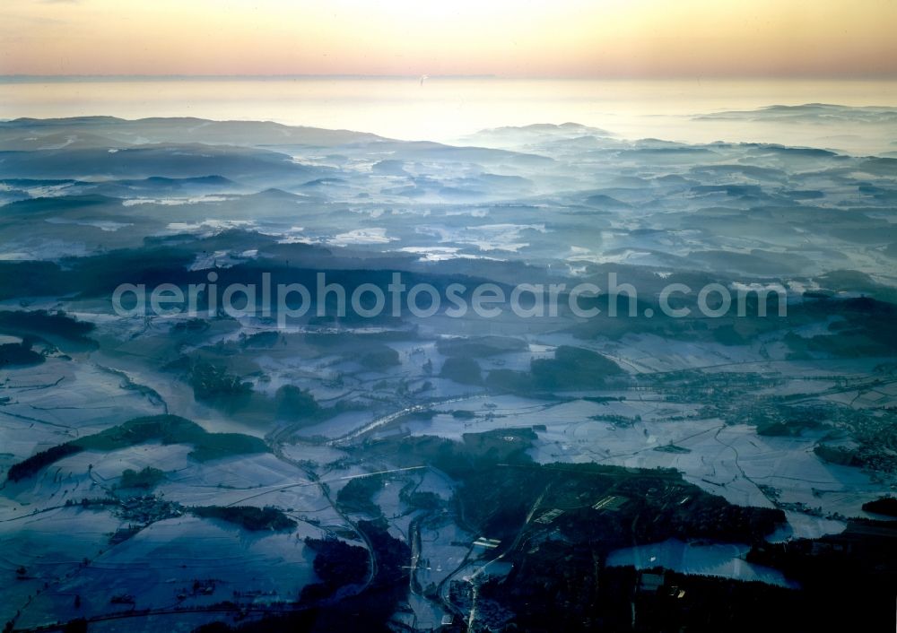 Rötz from the bird's eye view: Snow-covered landscape of the Upper Palatinate Forest around the town of Roetz in the state of Bavaria. The Forest is a mountain range along the border of Bavaria and the Czech Republic. It is 100km long and characterised by forest and wooded areas, deep valleys, small villages and agriculture. View over the Southern Forest towards the West