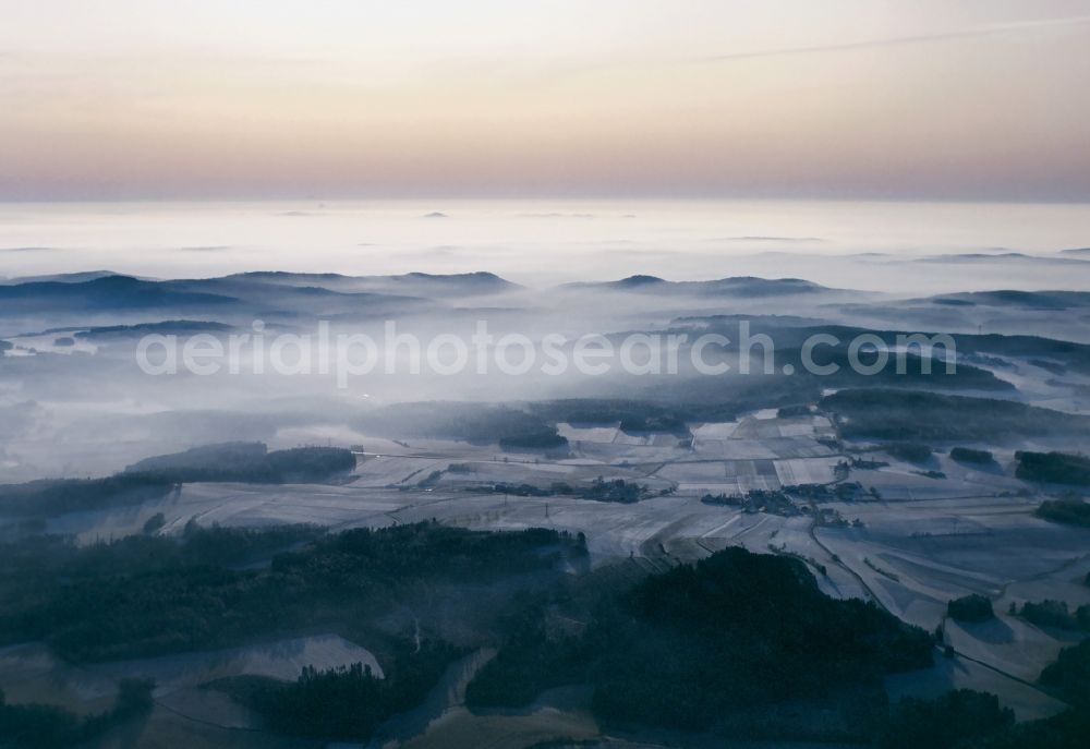 Aerial image Rötz - Snow-covered landscape of the Upper Palatinate Forest around the town of Roetz in the state of Bavaria. The Forest is a mountain range along the border of Bavaria and the Czech Republic. It is 100km long and characterised by forest and wooded areas, deep valleys, small villages and agriculture. View over the Southern Forest towards the West