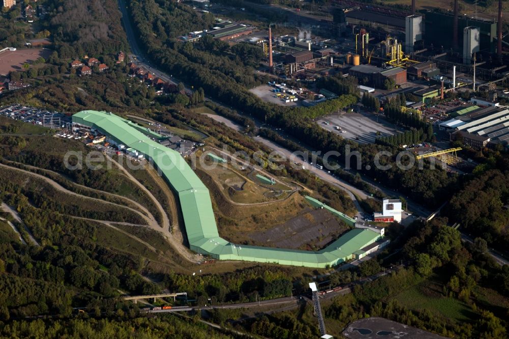 Aerial photograph Bottrop - The mine Prosper and the alpine center in Bottrop in the state of North Rhine-Westphalia. The brown coal pit is still in use today but the area visible here is also used differently. There is the Malakow Tower - a industrial memorial site - , as well as residential areas. It is also home to the alpine center, the longest indoor skiing slope in the world, a summer coasting slide, a ropes course and a paintball hall