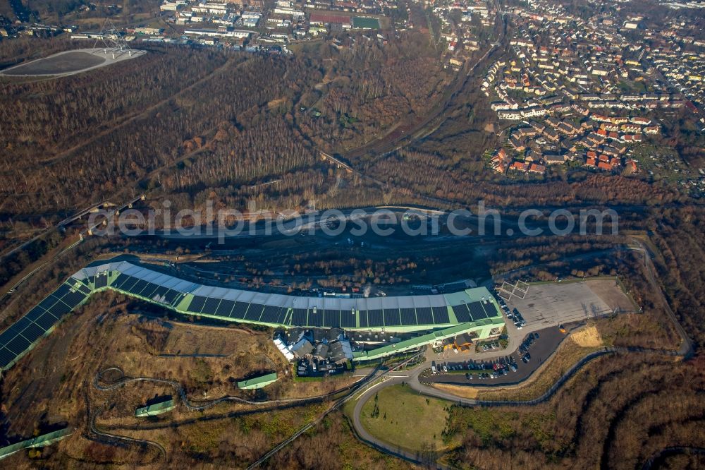 Bottrop from above - The mine Prosper and the alpine center in Bottrop in the state of North Rhine-Westphalia. The brown coal pit is still in use today but the area visible here is also used differently. There is the Malakow Tower - a industrial memorial site - , as well as residential areas. It is also home to the alpine center, the longest indoor skiing slope in the world, a summer coasting slide, a ropes course and a paintball hall