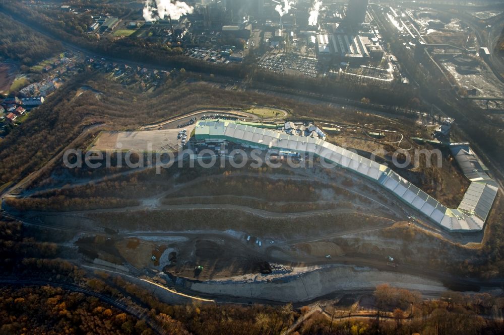 Aerial image Bottrop - The mine Prosper and the alpine center in Bottrop in the state of North Rhine-Westphalia. The brown coal pit is still in use today but the area visible here is also used differently. There is the Malakow Tower - a industrial memorial site - , as well as residential areas. It is also home to the alpine center, the longest indoor skiing slope in the world, a summer coasting slide, a ropes course and a paintball hall