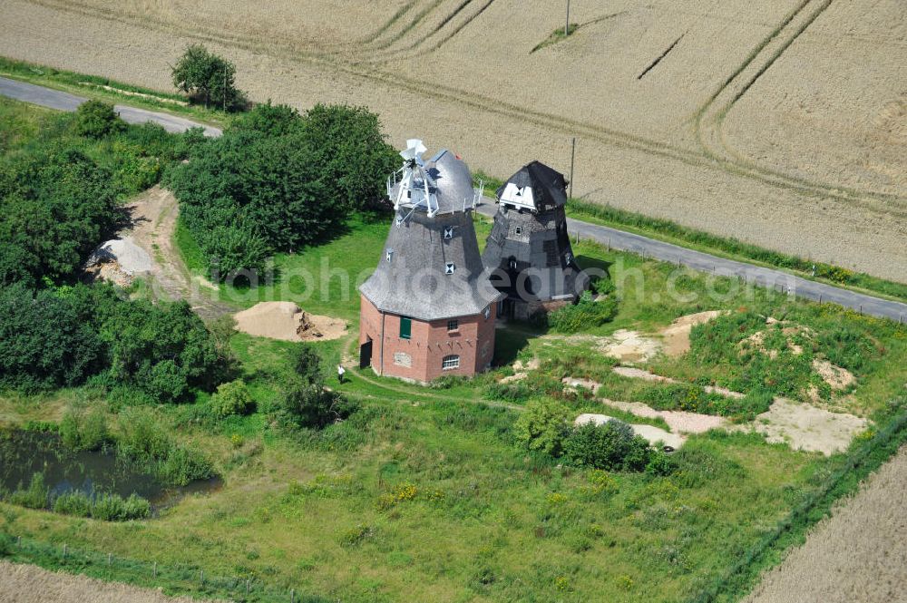 Neu Vorwerk from the bird's eye view: Blick auf die Zwillingsmühlen von Neu Vorwerk in Mecklenburg-Vorpommern. Bei diesem einzigartigen technischen Denkmal auf dem Mühlenberg zwischen Neu Vorwerk und Alt Vorwerk präsentieren sich dem Besucher zwei Windmühlen als Wahrzeichen nebeneinan der. 1847 kam es zur Errichtung des Erdholländers auf dem Gut Alt Vorwerk. 1949 kam es zum Neubau des großes Galerieholländers. Er stellt wohl den letzten Windmühlenneubau Deutschlands dar. Twin Mills of New Vorwerk.