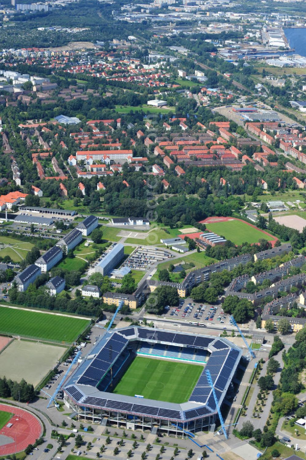 Aerial image Rostock - Die DKB-Arena (von 1954 bis 2007 Ostseestadion) ist ein Fußballstadion in der Hansestadt Rostock, das als Veranstaltungsort insbesondere für Heimspiele des F.C. Hansa Rostock genutzt wird. Die Ostseestadion GmbH & Co. KG mit dem F.C. Hansa Rostock als einzigem Kommanditisten ist Betreiber der DKB-Arena. Im Dezember 2010 wurde auf dem Dach der DKB-Arena eine Solaranlage fertiggestellt, deren Betreiber Paribus northenergy mit dieser rund 600.000 kWh Strom jährlich produzieren will. The DKB-Arena, the stadium is a football stadium in the Hanseatic city of Rostock, as the venue especially for home games of FC Hansa Rostock is used.