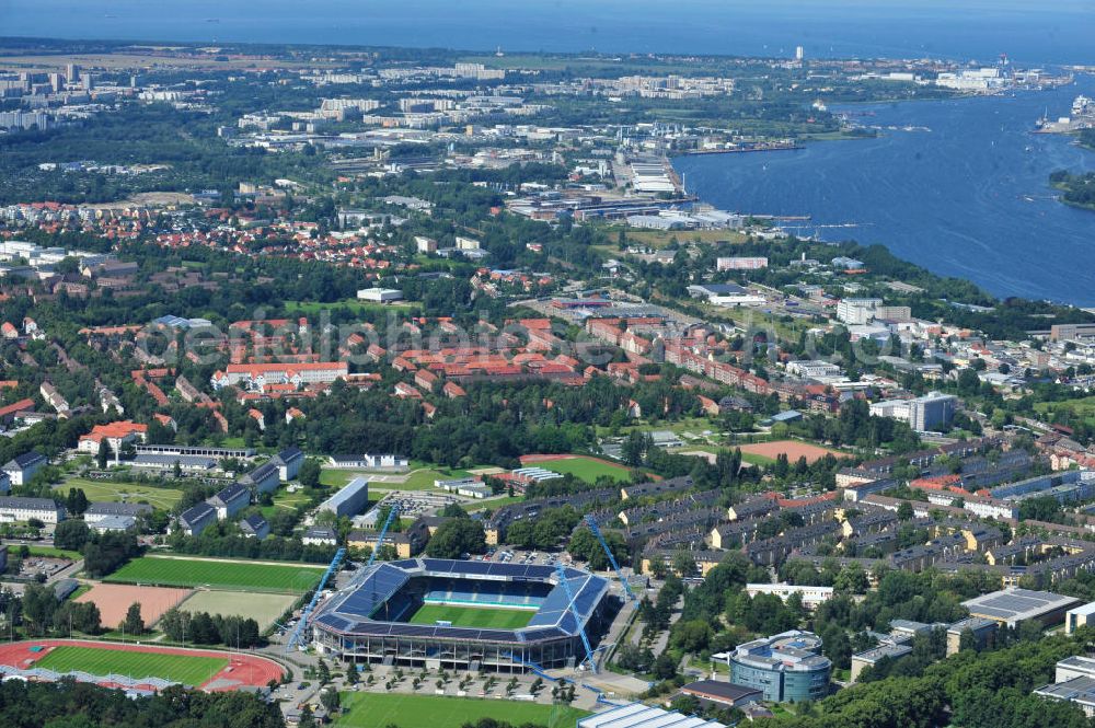 Aerial photograph Rostock - Die DKB-Arena (von 1954 bis 2007 Ostseestadion) ist ein Fußballstadion in der Hansestadt Rostock, das als Veranstaltungsort insbesondere für Heimspiele des F.C. Hansa Rostock genutzt wird. Die Ostseestadion GmbH & Co. KG mit dem F.C. Hansa Rostock als einzigem Kommanditisten ist Betreiber der DKB-Arena. Im Dezember 2010 wurde auf dem Dach der DKB-Arena eine Solaranlage fertiggestellt, deren Betreiber Paribus northenergy mit dieser rund 600.000 kWh Strom jährlich produzieren will. The DKB-Arena, the stadium is a football stadium in the Hanseatic city of Rostock, as the venue especially for home games of FC Hansa Rostock is used.