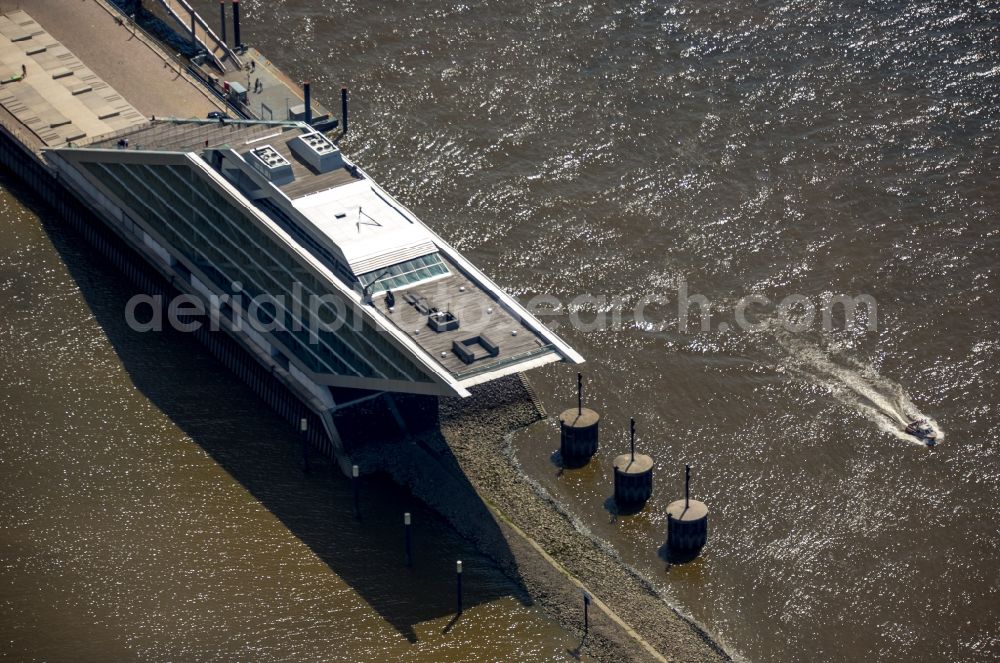 Aerial photograph Hamburg - Dockland Office building in the Dockland region of the Free and Hanseatic city of Hamburg in Germany. The distinct building with its architecture, glass facade and step-like shape is located on an artificial landstrip in the water