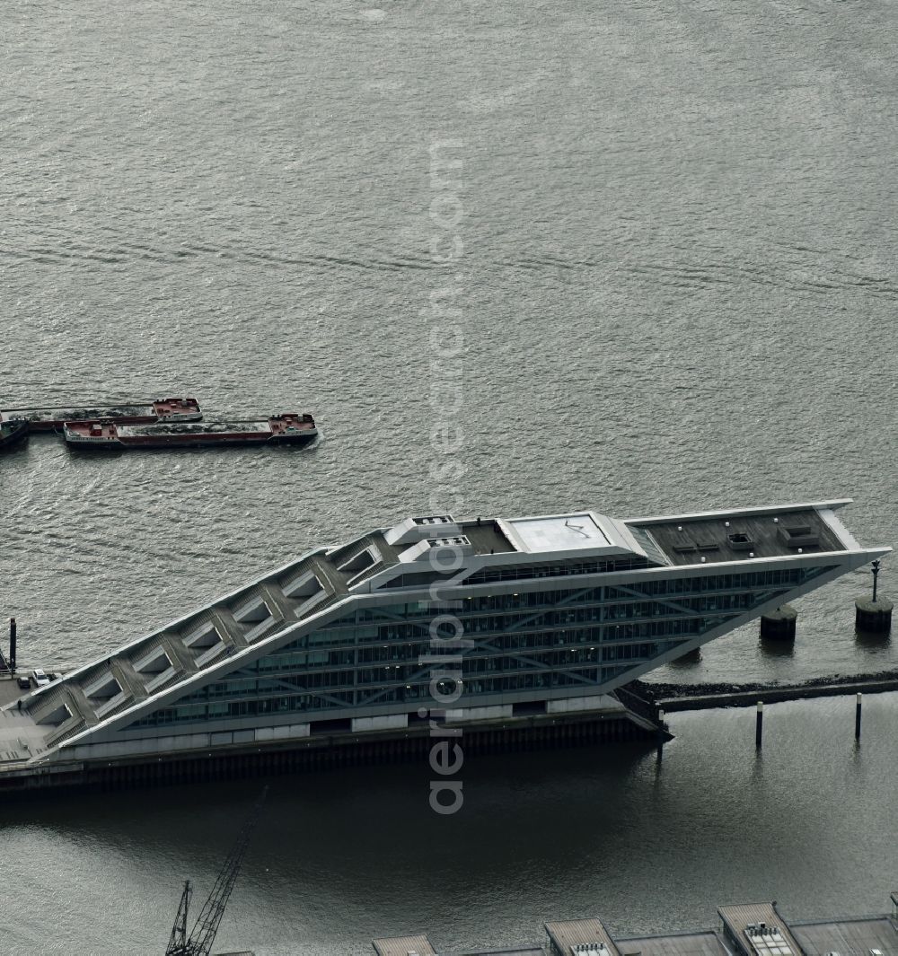 Hamburg from the bird's eye view: Dockland Office building in the Dockland region of the Free and Hanseatic city of Hamburg in Germany. The distinct building with its architecture, glass facade and step-like shape was designed by Hadi Teherani and is located on an artificial landstrip in the water