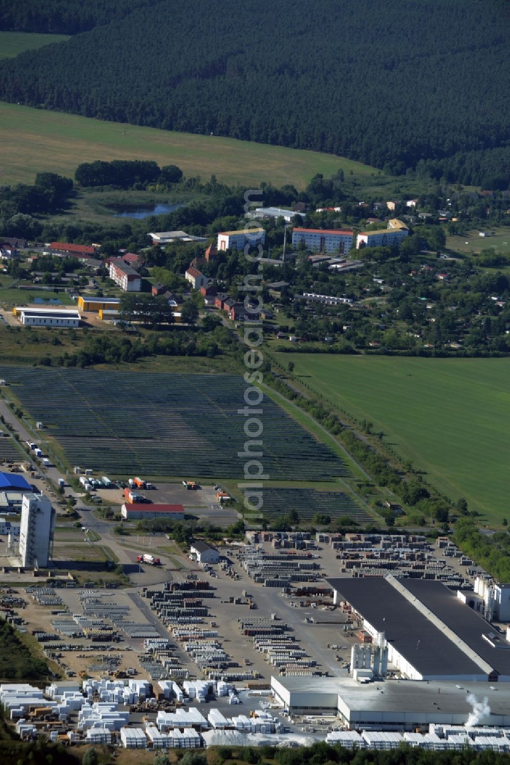 Aerial photograph Hohen Wangelin - Building material works, solar plant and view of the borough of Hohen Wangelin in the state of Mecklenburg - Western Pomerania. The borough is located in the county district of Mecklenburgische Seenplatte. The works are located in the North of the borough