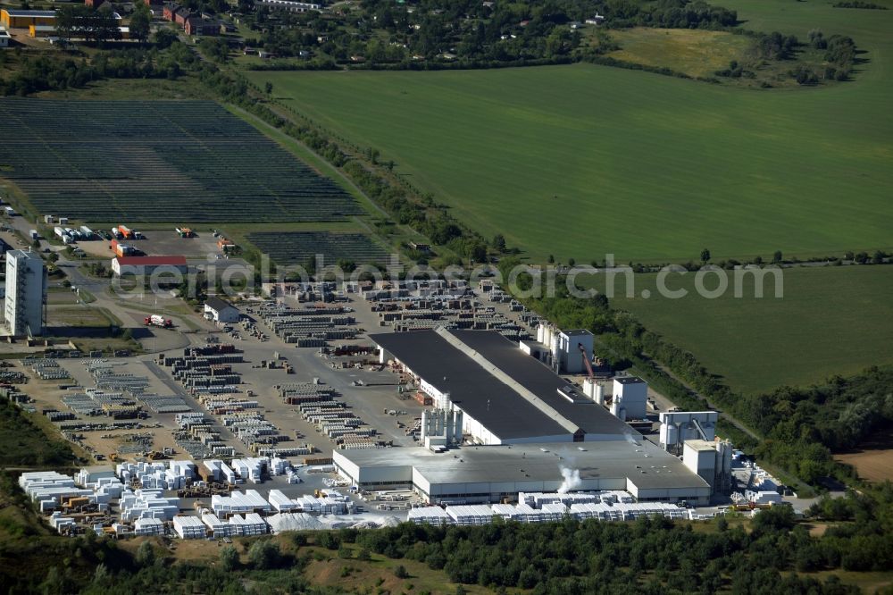 Hohen Wangelin from the bird's eye view: Building material works, solar plant and view of the borough of Hohen Wangelin in the state of Mecklenburg - Western Pomerania. The borough is located in the county district of Mecklenburgische Seenplatte. The works are located in the North of the borough