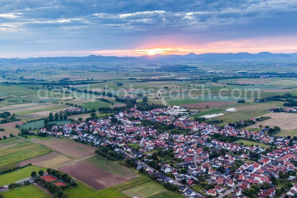 Aerial image Minfeld - Village - view at sunset on the edge of agricultural fields and farmland in Minfeld in the state Rhineland-Palatinate, Germany