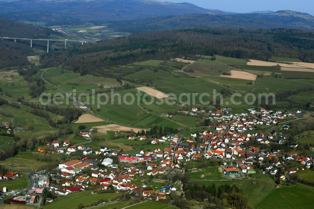 Aerial image Oberzell - Agricultural land, meadows and forests surround the settlement area of a??a??the village in Oberzell in the state of Hesse, Germany