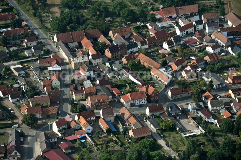 Aerial photograph Grüningen - View of the village of Grueningen in the state of Thuringia. The village is surrounded by agricultural fields and consists of residential buildings and farms