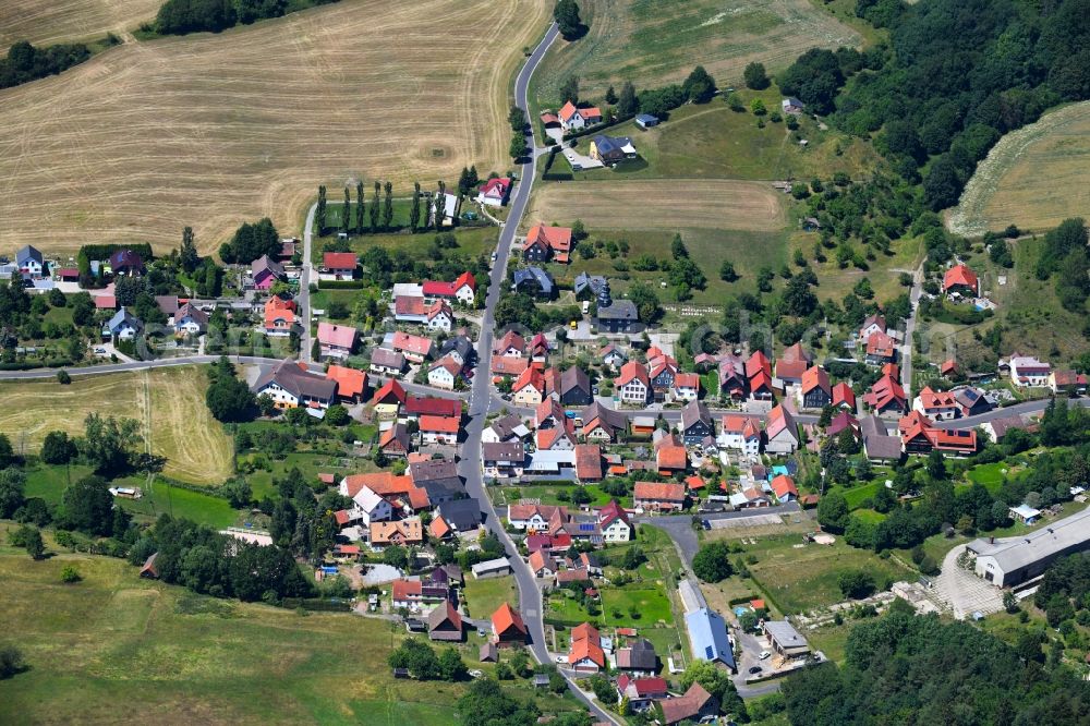 Bischofrod from the bird's eye view: Village - view on the edge of agricultural fields and farmland in Bischofrod in the state Thuringia, Germany