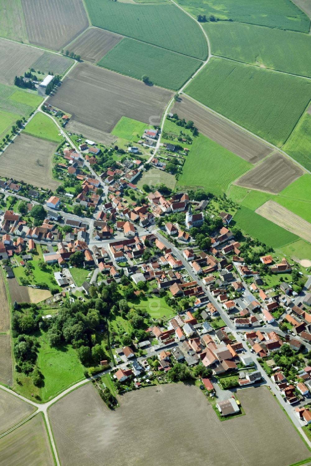 Goßmannsdorf from the bird's eye view: Village - view on the edge of agricultural fields and farmland in Gossmannsdorf in the state Bavaria, Germany