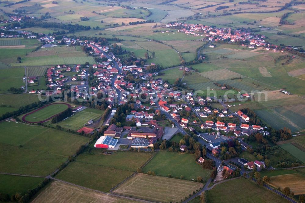 Aerial image Grebenhain - Village - view on the edge of agricultural fields and farmland in Grebenhain in the state Hesse, Germany