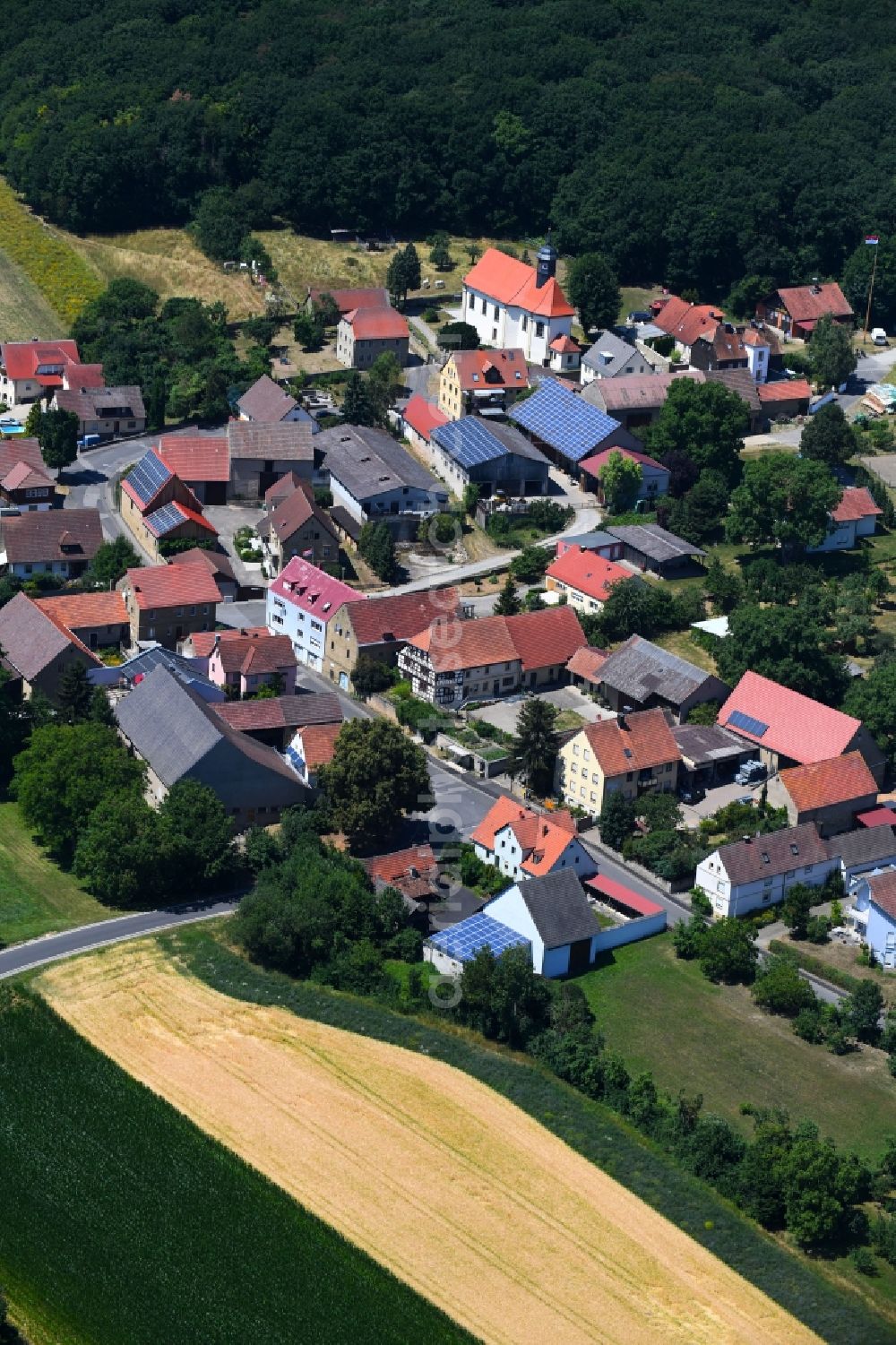 Aerial image Hilpertshausen - Village - view on the edge of agricultural fields and farmland in Hilpertshausen in the state Bavaria, Germany