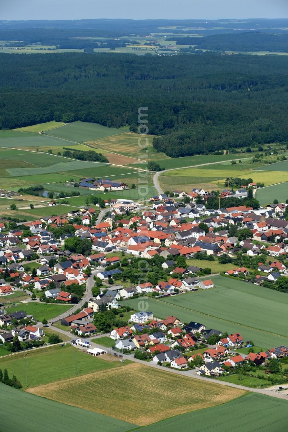 Kasing from the bird's eye view: Village - view on the edge of agricultural fields and farmland in Kasing in the state Bavaria, Germany