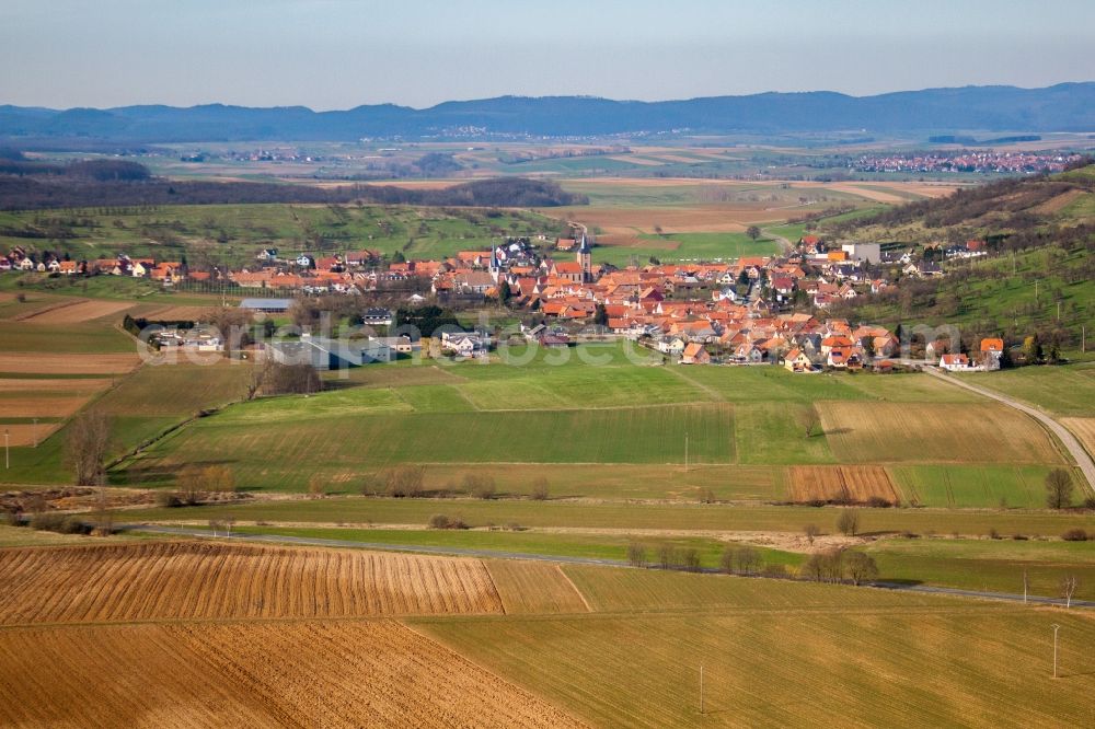 Kirrwiller from the bird's eye view: Village - view on the edge of agricultural fields and farmland in Kirrwiller in Grand Est, France