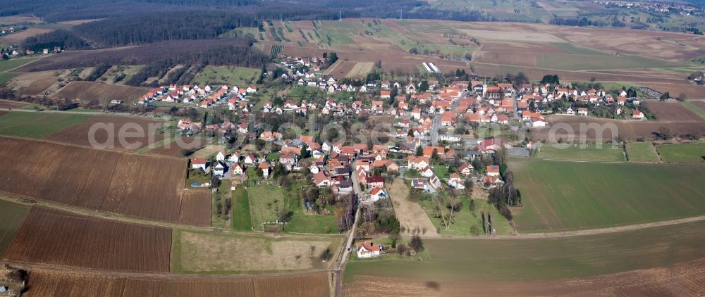 Aerial image Kutzenhausen - Village - view on the edge of agricultural fields and farmland in Kutzenhausen in Grand Est, France