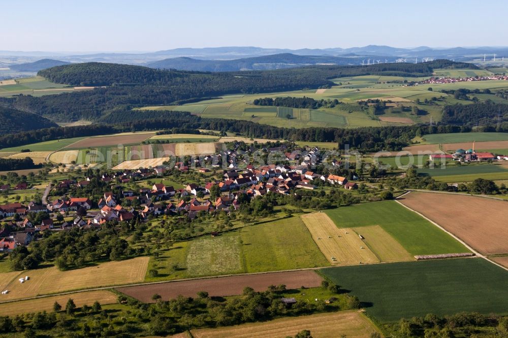 Trendelburg from the bird's eye view: Village - view on the edge of agricultural fields and farmland in the district Langenthal in Trendelburg in the state Hesse, Germany