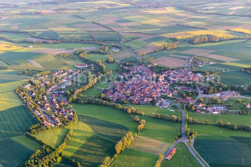 Hofheim in Unterfranken from the bird's eye view: Village - view on the edge of agricultural fields and farmland in the district Ruegheim in Hofheim in Unterfranken in the state Bavaria, Germany