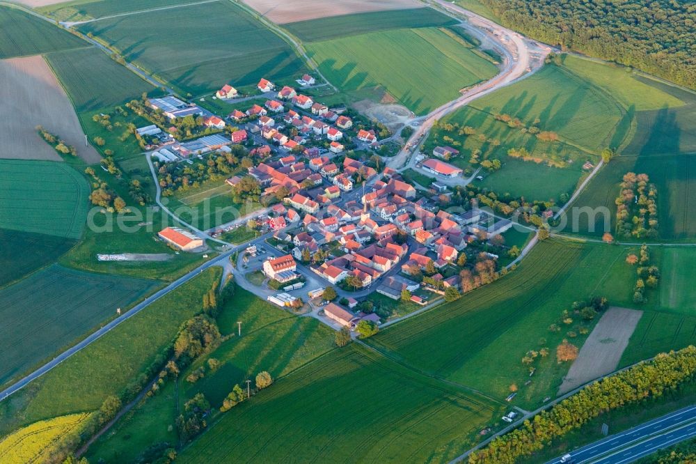 Aerial image Wasserlosen - Village - view on the edge of agricultural fields and farmland in the district Ruetschenhausen in Wasserlosen in the state Bavaria, Germany