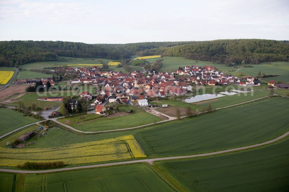 Aerial image Rauhenebrach - Village - view on the edge of agricultural fields and farmland in Rauhenebrach in the state Bavaria, Germany