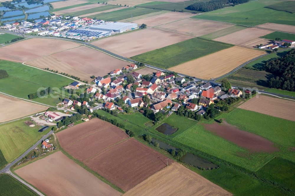 Aerial image Reinersdorf - Village - view on the edge of agricultural fields and farmland in Reinersdorf in the state Bavaria, Germany